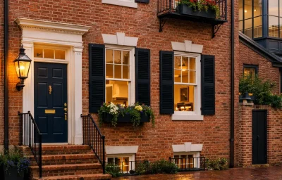 xterior view of an 18th-century row home during a historic home renovation in Alexandria VA, featuring restored Federal-style brickwork and BAR-compliant wood windows by Valor Builder.
